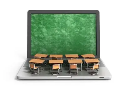 an illustration of a laptop computer with miniature desks and chairs on the keyboard